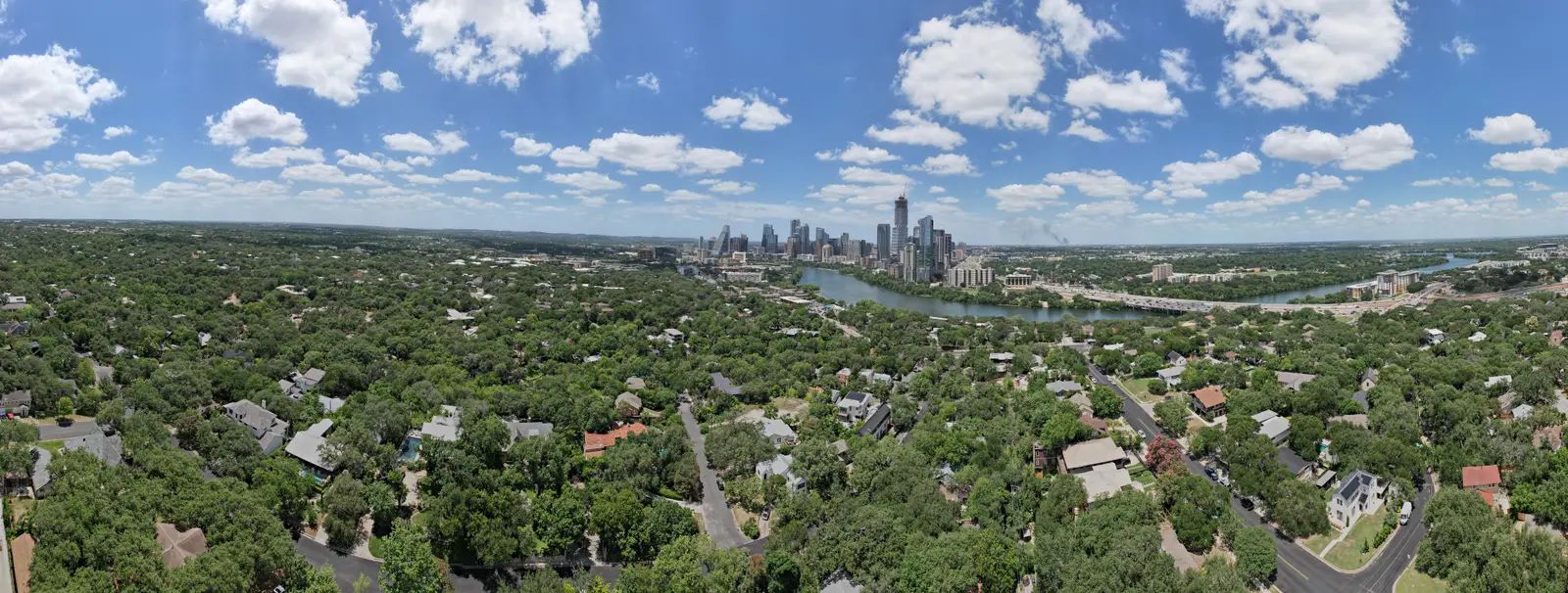 Aerial view of Austin neighborhoods with downtown skyline and Lady Bird Lake