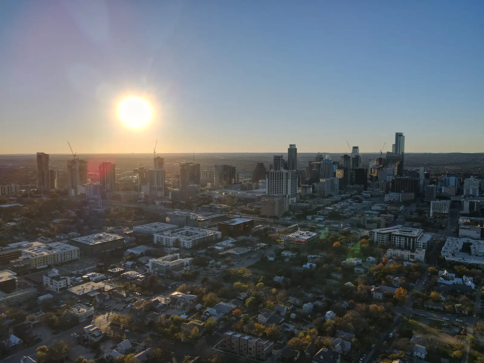 Austin skyline at golden hour with sun setting over downtown